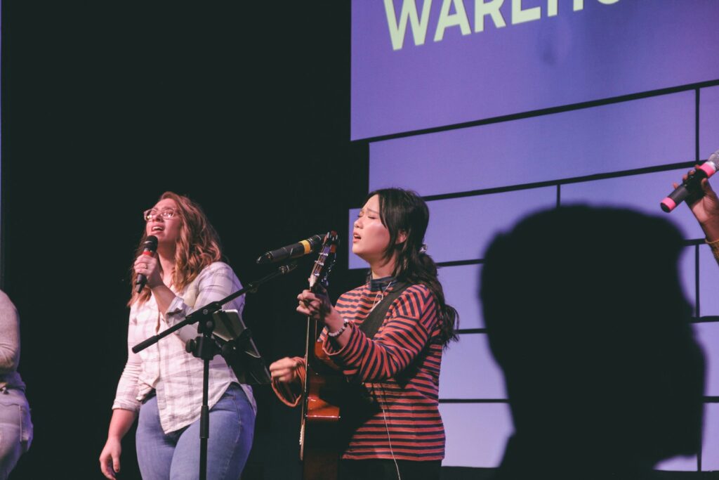 photography of two singing women