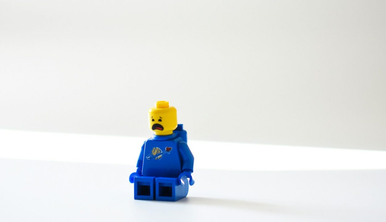 blue lego minifig on white surface