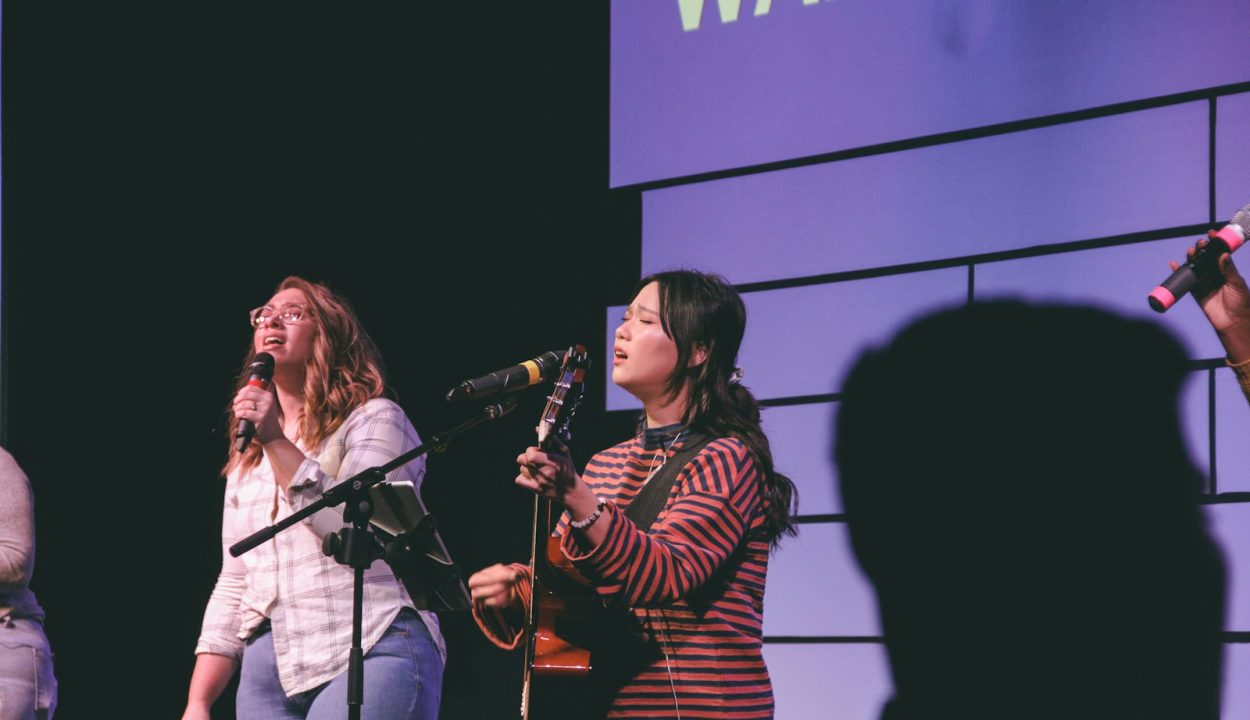 photography of two singing women